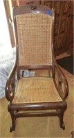 Wal. carved roses Lincoln rocker w/cane seat &
