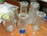 5 One pint milk bottles some w/advertising & a