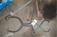 Ice tongs and 3 pipe wrenches