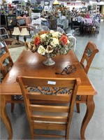 Wooden table with four chairs and iron scroll