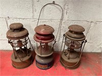Antique brass and metal Tilley lamps.