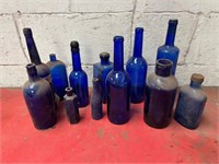 Blue glass bottles of various shapes.