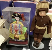 1 Asian Doll In Case, 1 German/Dutch Child Doll.