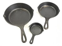 Three small cast iron skillet pans