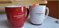 Two Starbucks mugs