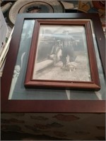 Stack of old framed pictures
