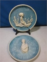 Pair of raised relief figure collector plates