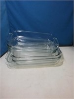 Stack of five clear glass baking casserole dishes