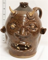 Brown face jug w/ devil horns