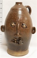 Brown face jug w/ cigar