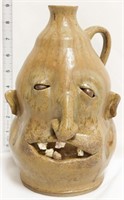 Tan face jug w/ crooked nose & 5 teeth