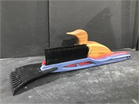 Pair of snowbrushes and a wooden duck penny bank.