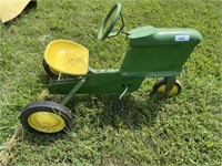 Toy pedal tractor painted in John Deere colors