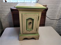 Wooden end table with cabinet door front.
