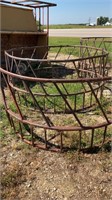 Round bale feeder with extra