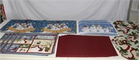 lot Christmas placemats and a table runner