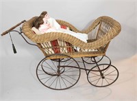 WICKER CARRIAGE AND TWO BISQUE-HEAD DOLLS