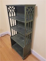 Wooden display shelf with decorative side panels.