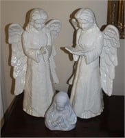 two hand made ceramic angels and a madonna