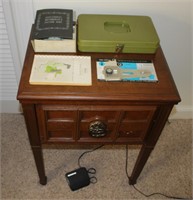 Kenmore sewing machine w accesories in cabinet