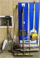 Contents of wall, including Brooms, Dust Pan, and