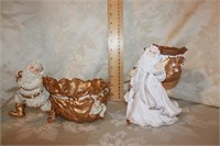 TWO RESIN SANTAS WITH BAGS - GOLD AND WHITE