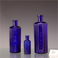 Three vintage cobalt blue apothecary bottles