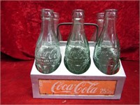 Coca cola bottles & aluminum carrier