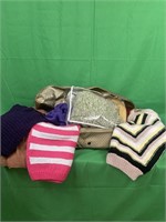 Blanket box full of handmade, knitted sweater and