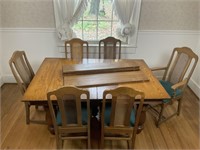 Oak table with 6 cane chairs and leaves