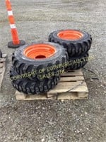 E.(4)new 10-16.5 skid steer tires on Bobcat wheels