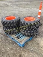 E.(4)new 12-16.5 skid steer tires on Bobcat wheels