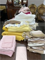 Table Full of Sheets, Blankets & Bed Spreads