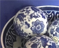 Blue and white decorative bowl with 3 balls