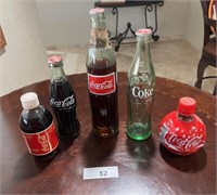 Coca Cola-5 Bottles-1 is empty