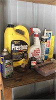 Shelf of misc fluids, organizer, grease gun