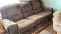 Reclining couch on wood riser approx 85”x40”