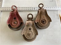 Three vintage pulleys