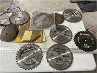 Assorted saw blades and grinding disks.  Some