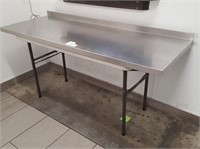 folding table with glued stainless top 63 x 23"