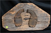 Pair of Ox Shoes nailed on a piece of barn wood wi
