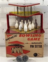 Vintage magnetic bowling game with pinsetter