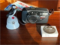 Newfoundland bell, Nikon camera, paperweight