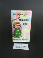 A Wind-Up Minuature Walking Doll