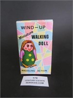 A Wind-Up Minuature Walking Doll