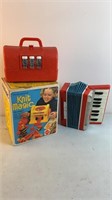 Vintage toys: accordion, doctor bag, Knit Magic