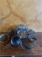 Assorted size cooking pots and strainers