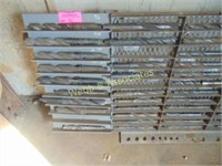 Assorted large drill bits and rack
