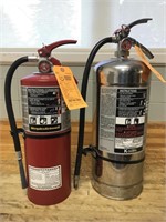 Pair of fire extinguishers. One is ABC and the