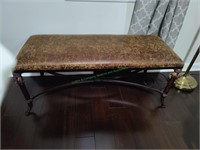 Metal bench with leather seat.